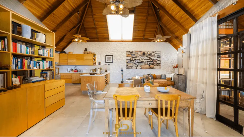 Cozy wooden interior with kitchen and dining area.