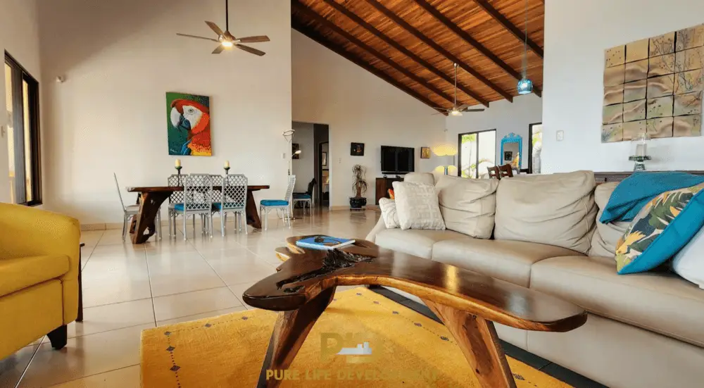 Spacious living room with modern decor and artwork.