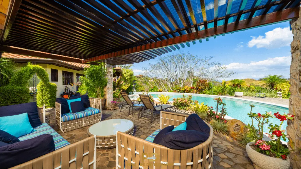 Covered patio with furniture by pool