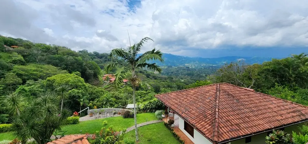 Scenic mountain view with lush greenery and house