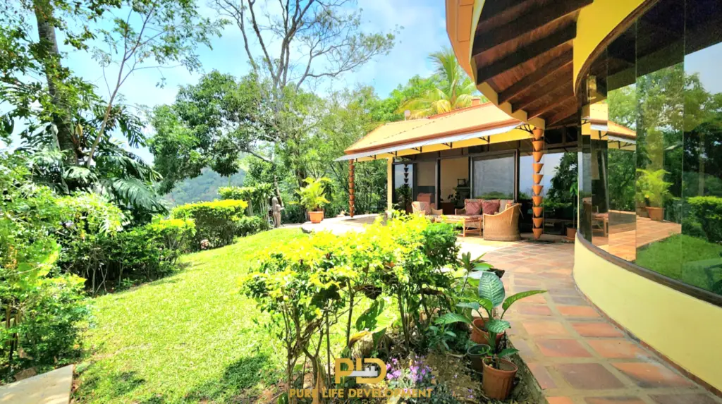 Tropical garden with modern house and patio view for sale in Atenas, Costa Rica.