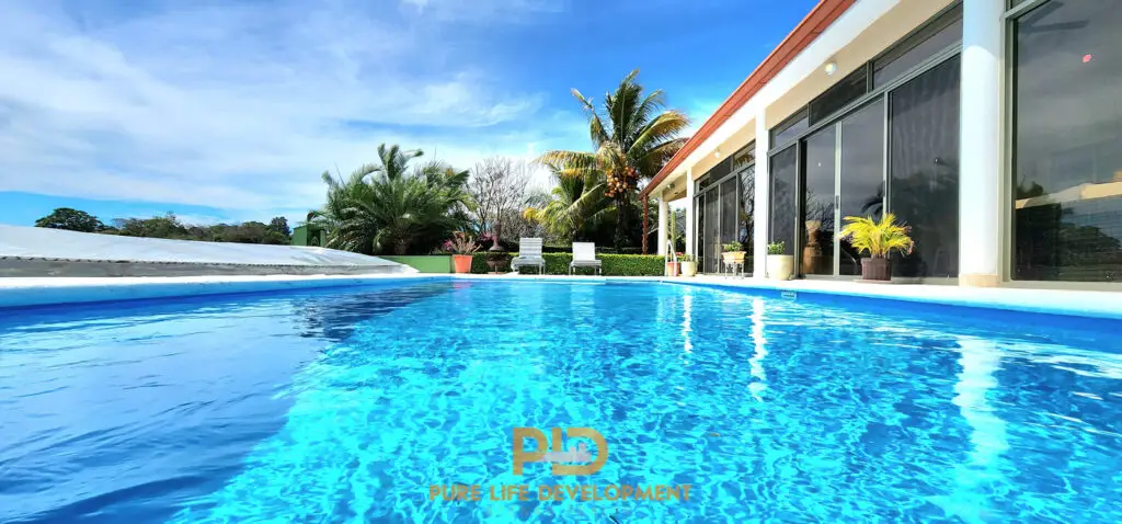 Luxury home with pool and palm trees in Atenas, Costa Rica for sale.