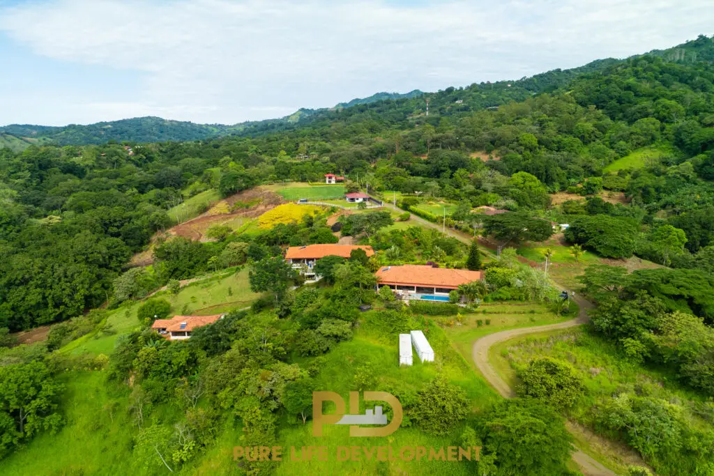 Aerial view of lush green landscape with buildings.