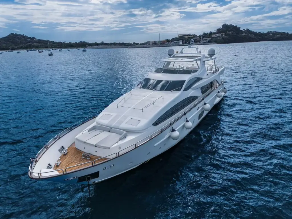 Luxury yacht sailing in blue ocean waters.