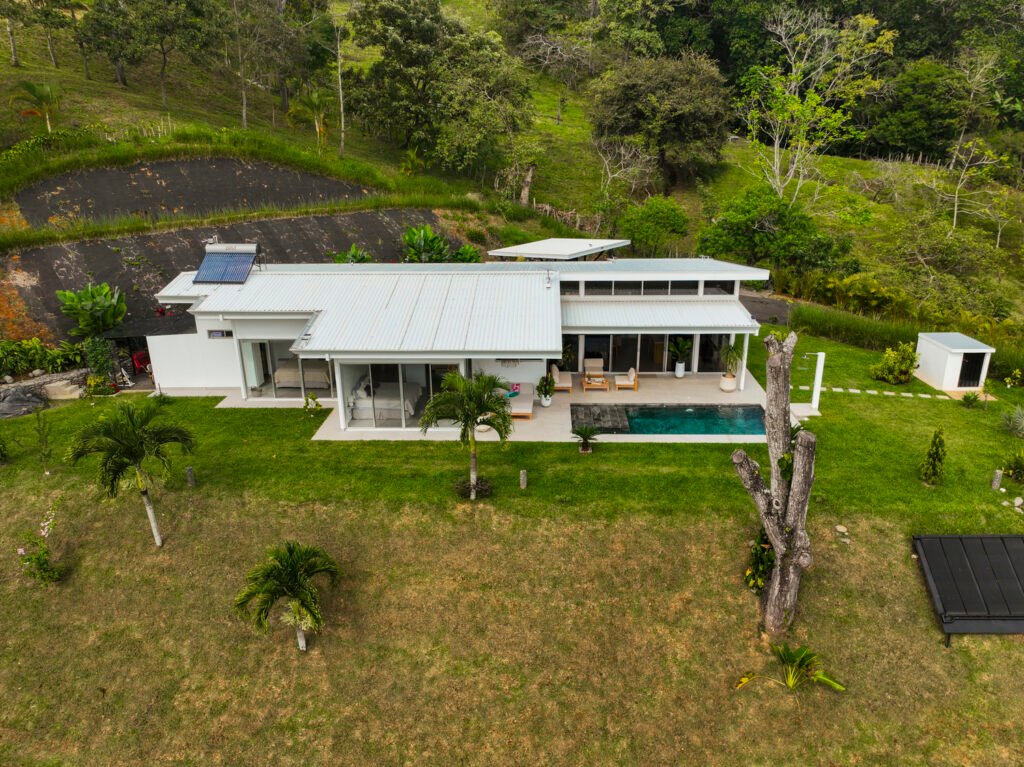Modern white house with solar panels and pool