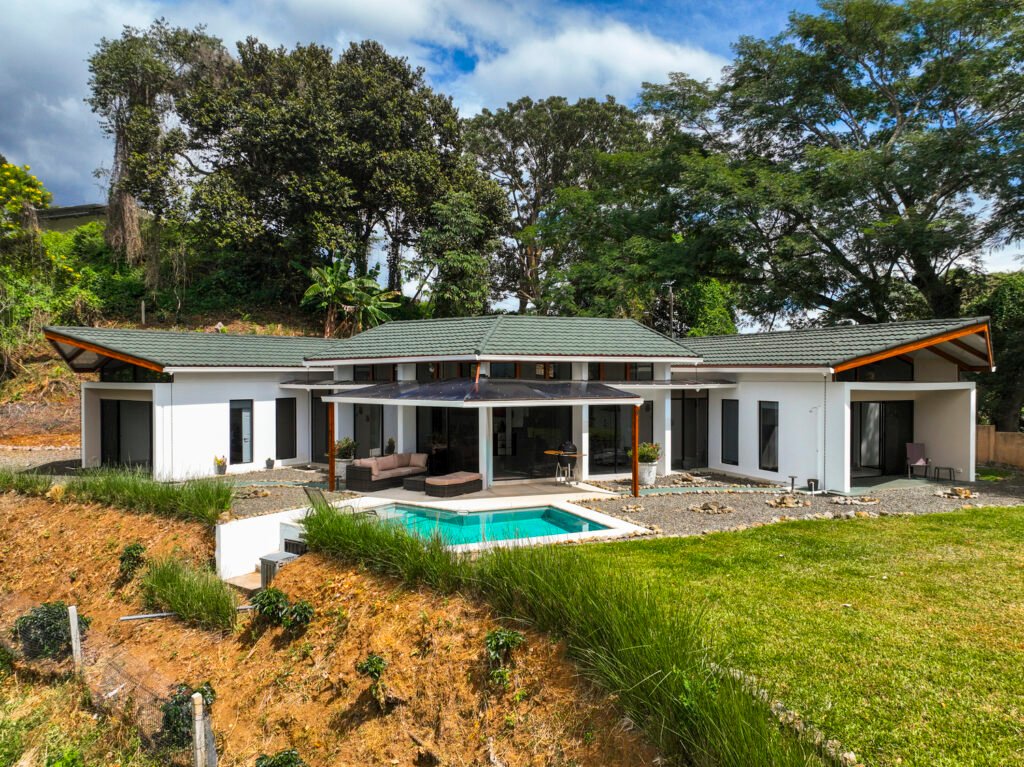 Modern house with pool and green surroundings