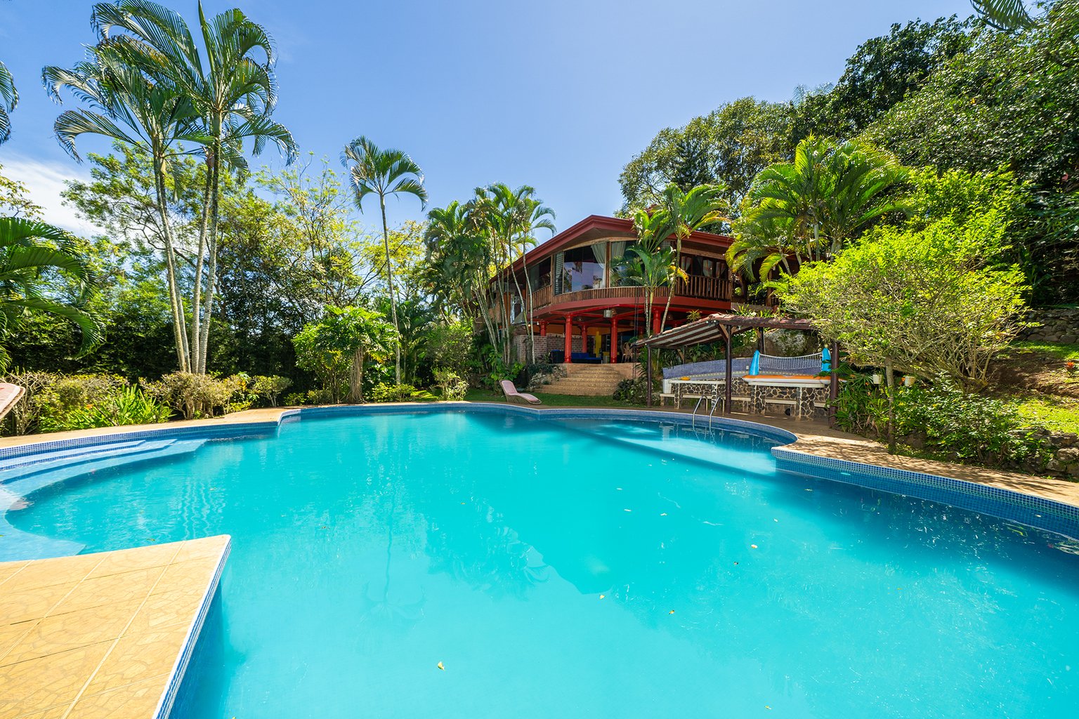 Tropical villa with pool and lush greenery