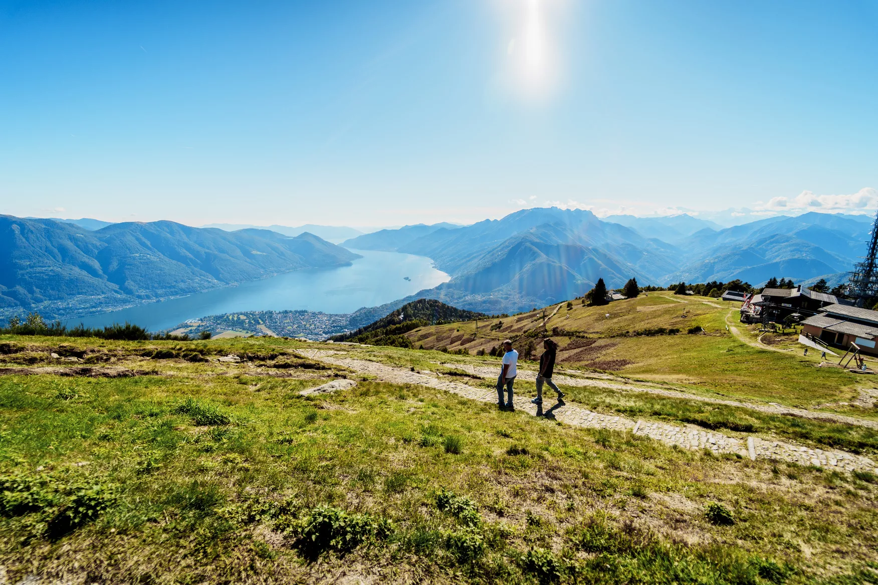 Scenic mountain landscape with hikers and lake view.