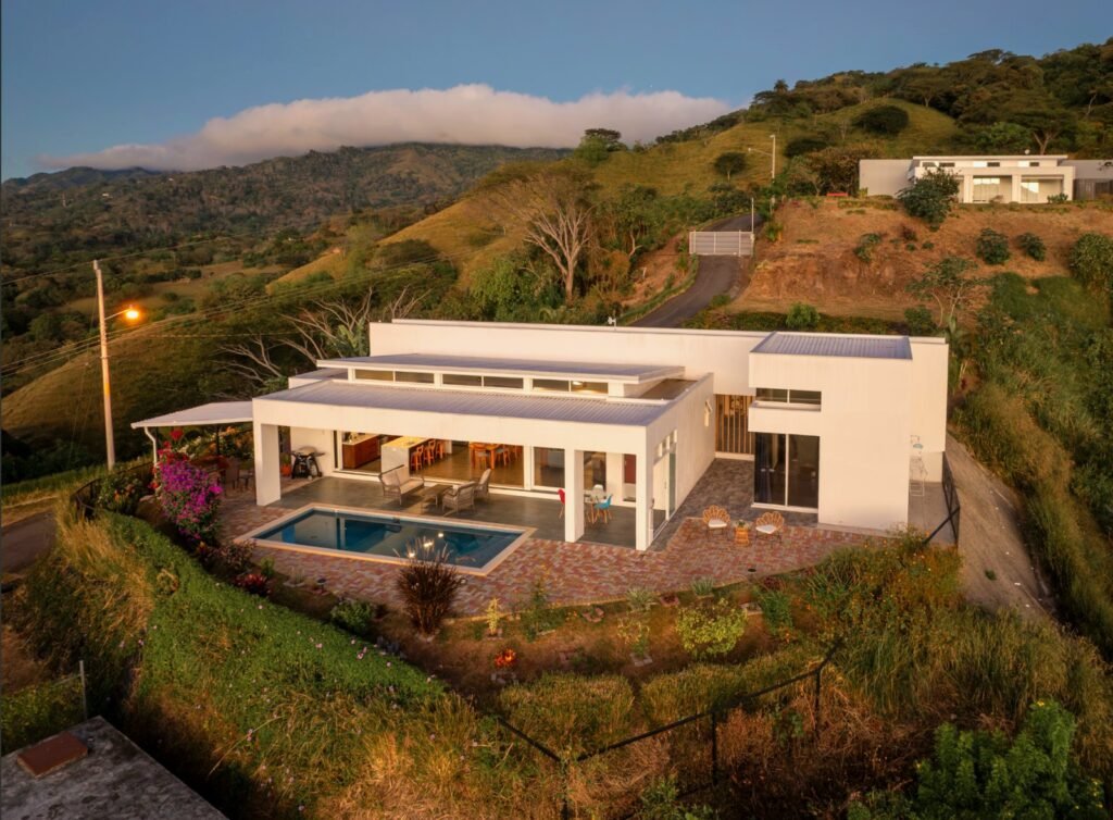 Modern hillside home with pool and scenic view.
