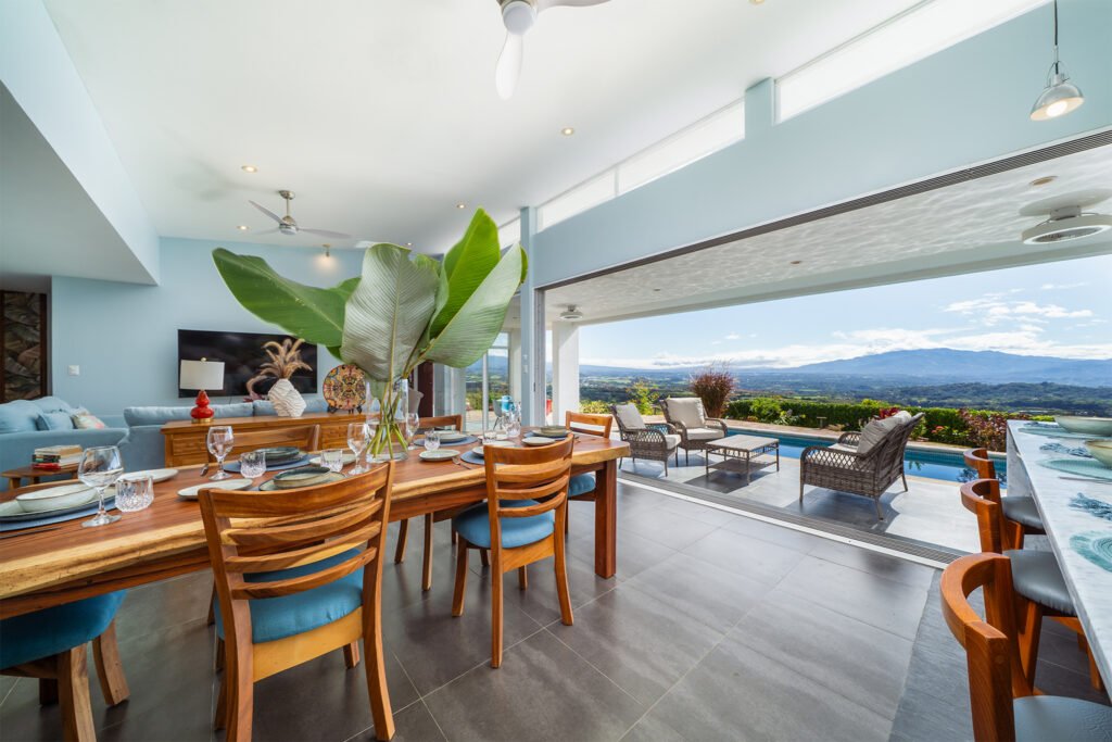 Luxury dining room with pool and mountain view.