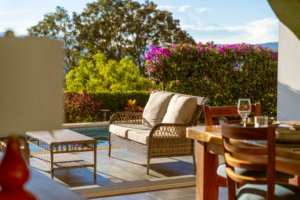 Outdoor patio with cozy seating and flowers