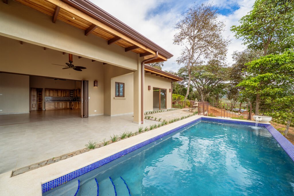 Modern house with pool and open patio view.