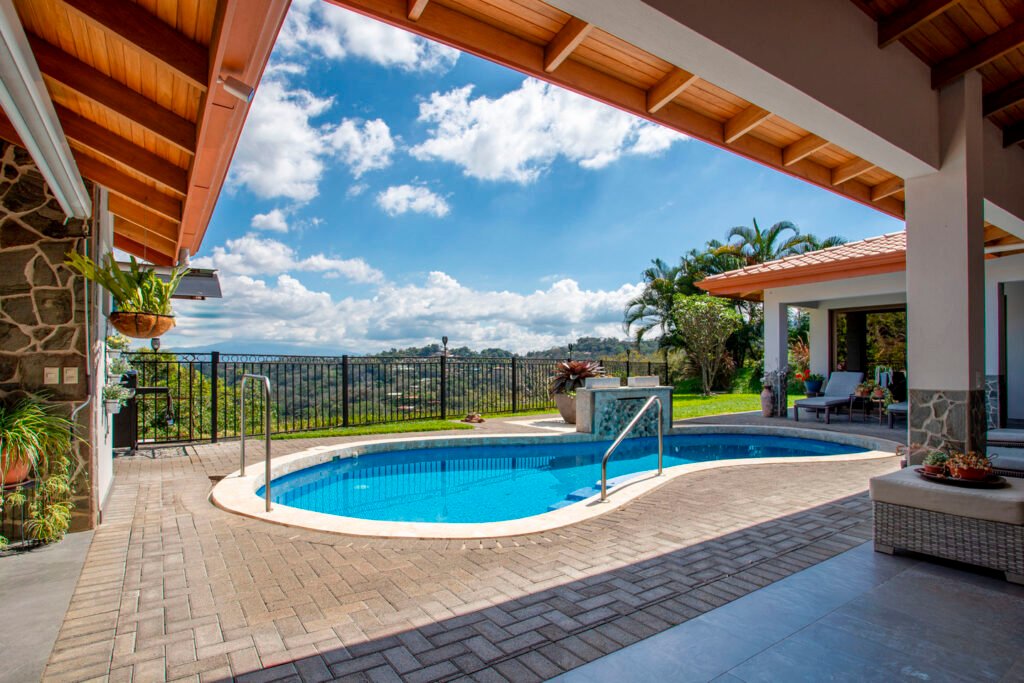 Modern patio pool overlooking lush hillside landscape