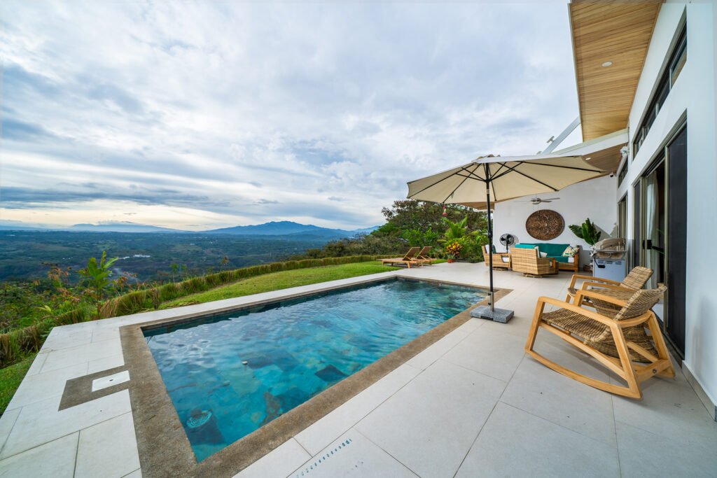Infinity pool overlooking lush valley and mountains