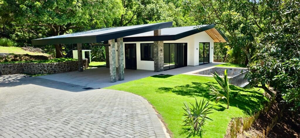 Modern single-story house with carport and lush lawn