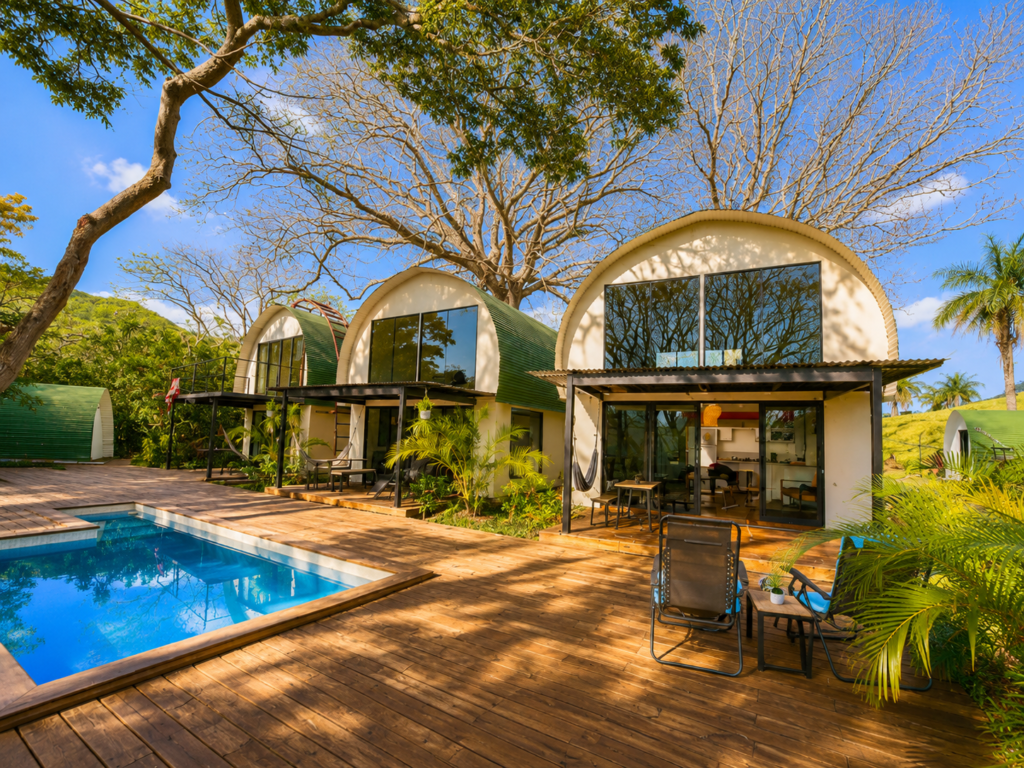 Modern curved cabins with pool in tropical setting