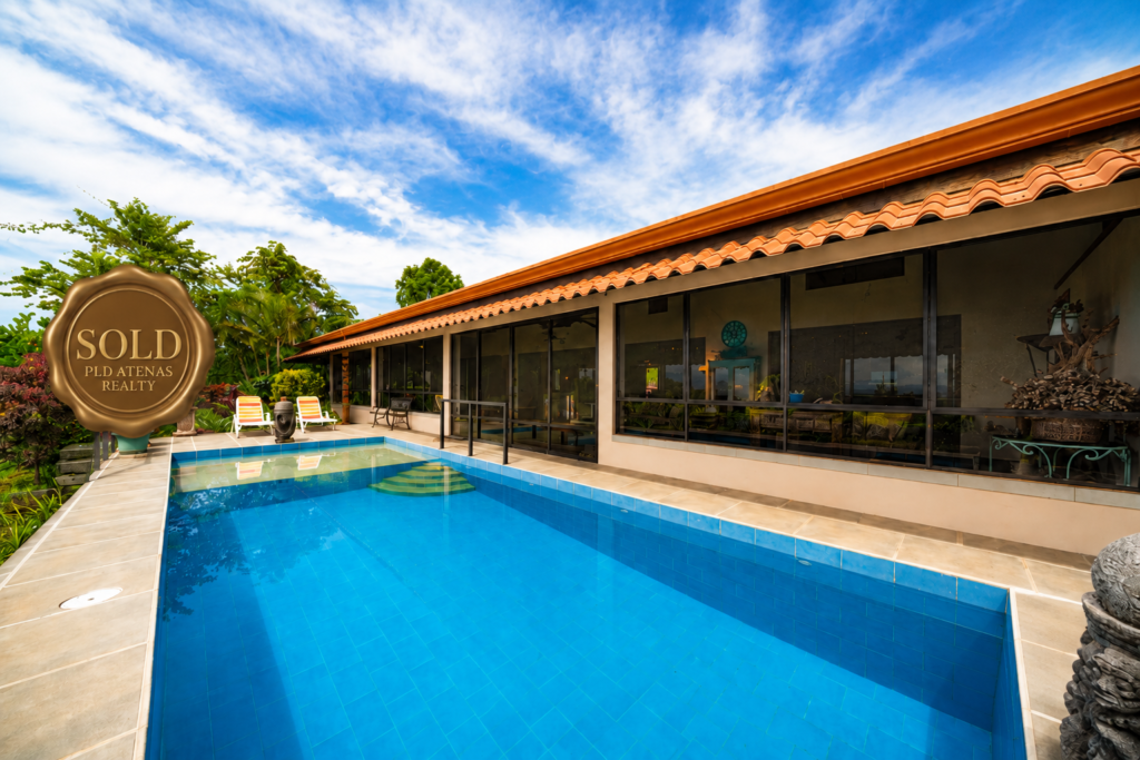 Modern home with pool and tropical landscaping