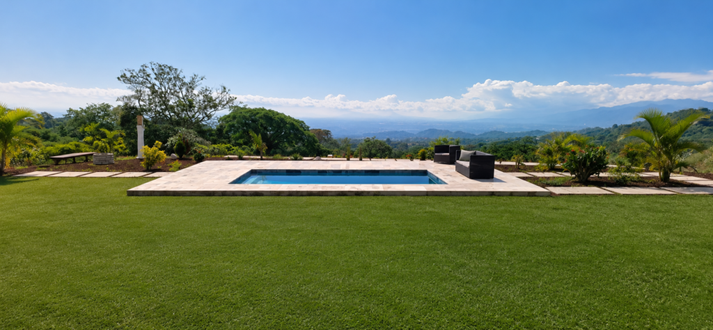 Infinity pool overlooking lush mountains and valley