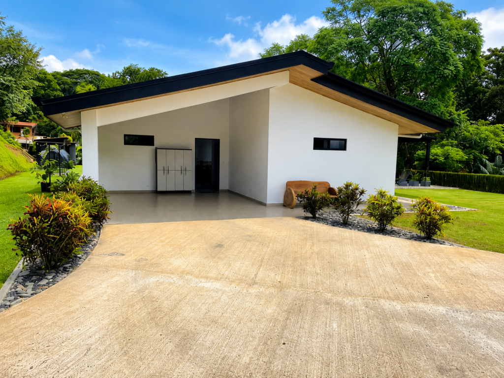 Modern white house with slanted roof and driveway