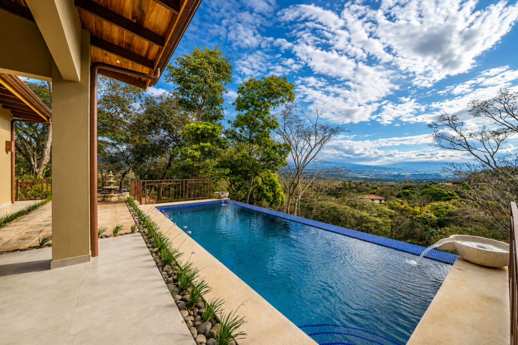 Infinity pool overlooking lush valley and mountains