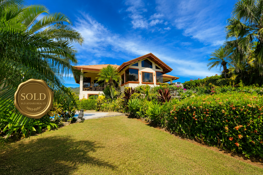 Tropical home with lush garden and sold badge
