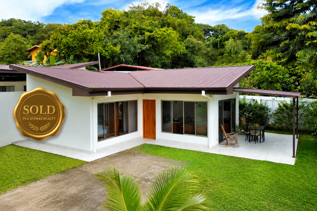 Modern single-story home with garden and sold badge