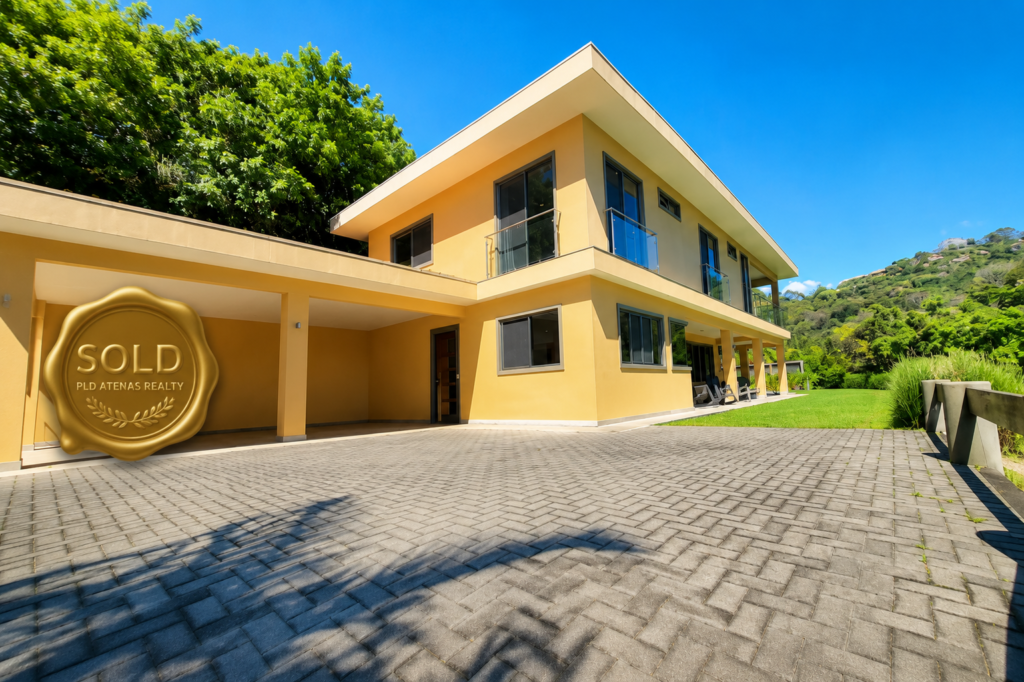 Modern two-story yellow house with sold seal