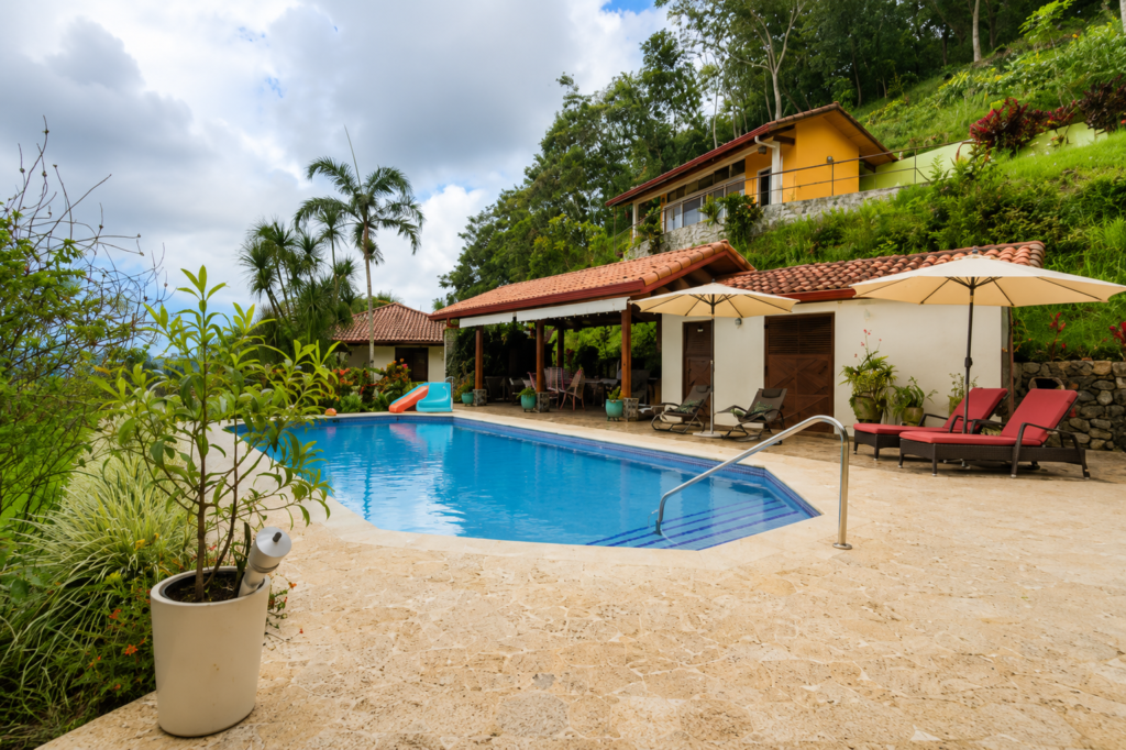 Tropical hillside villa with pool and lounge chairs