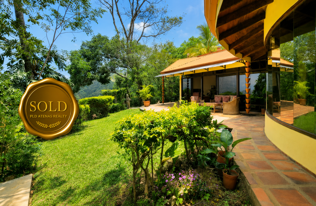 Tropical hillside home with lush garden and patio