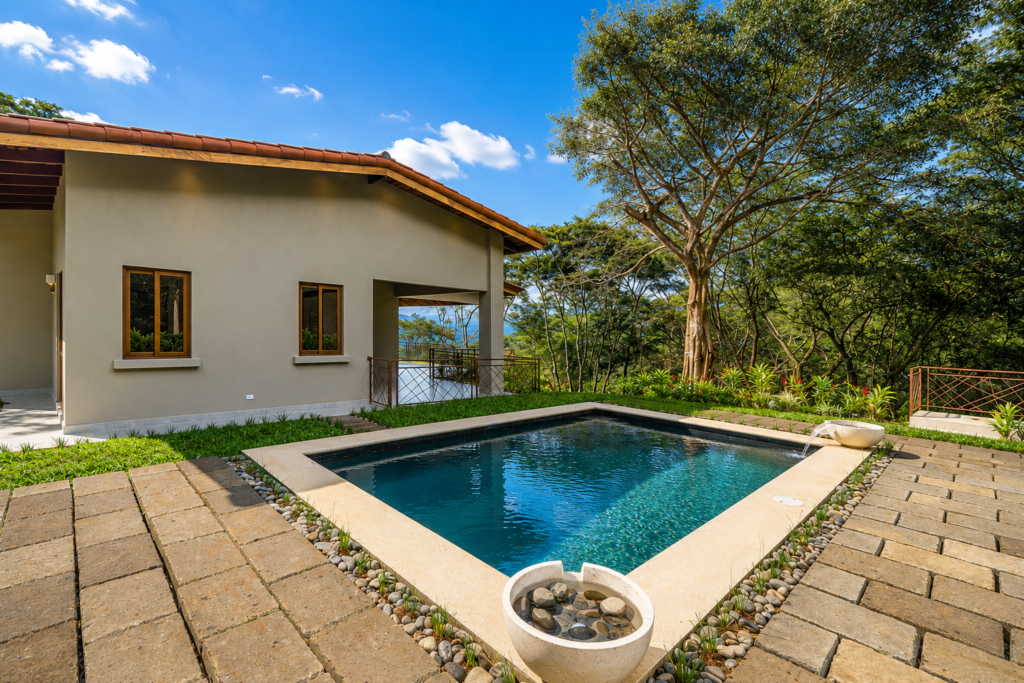 Modern home with backyard pool and trees