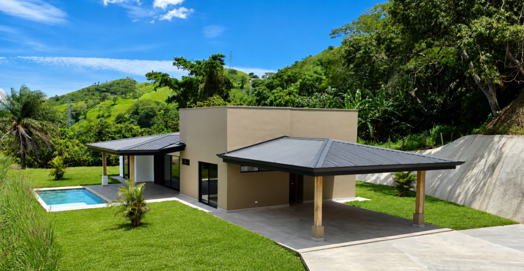 Modern house with pool in lush hillside setting