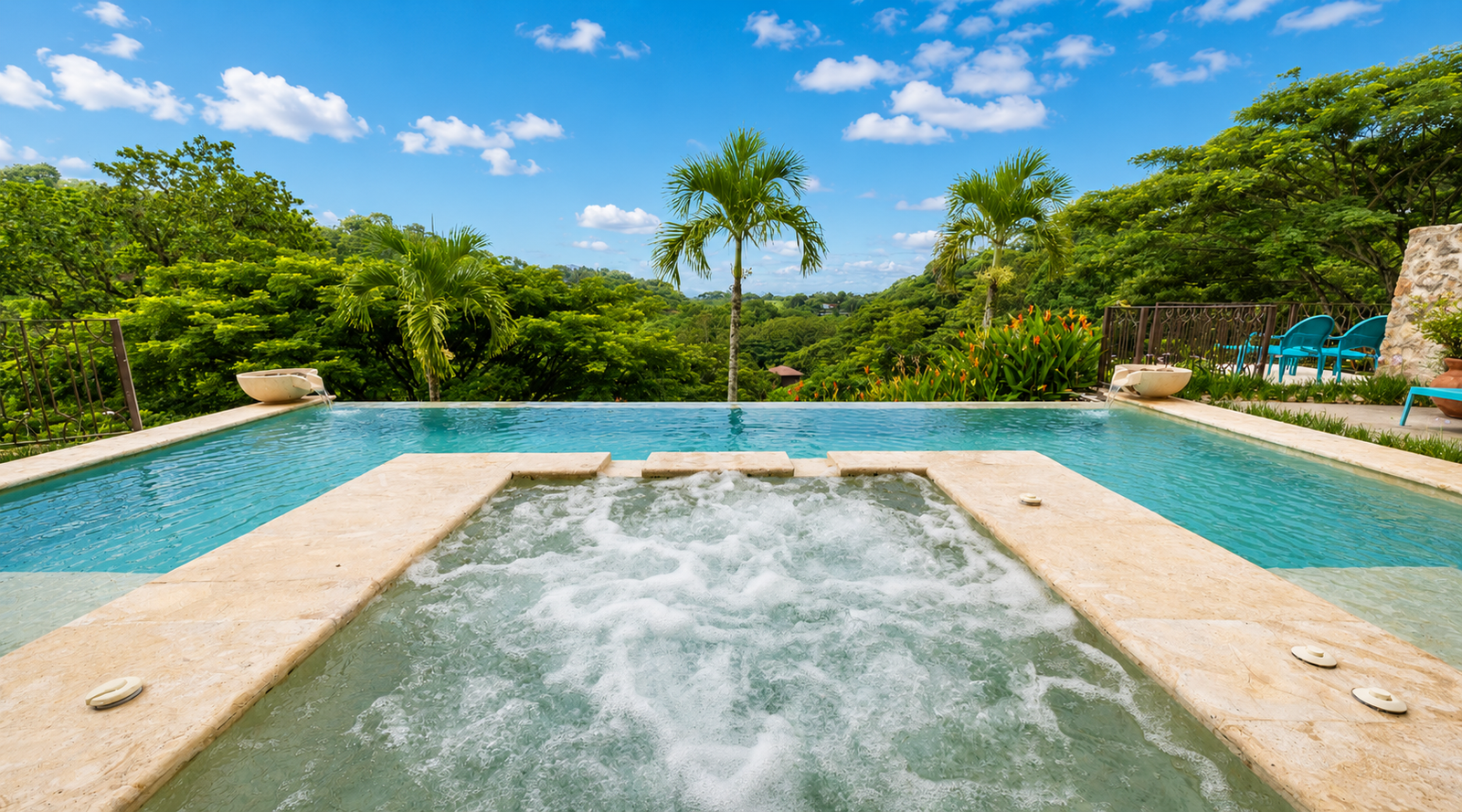 Infinity pool with hot tub overlooking tropical landscape