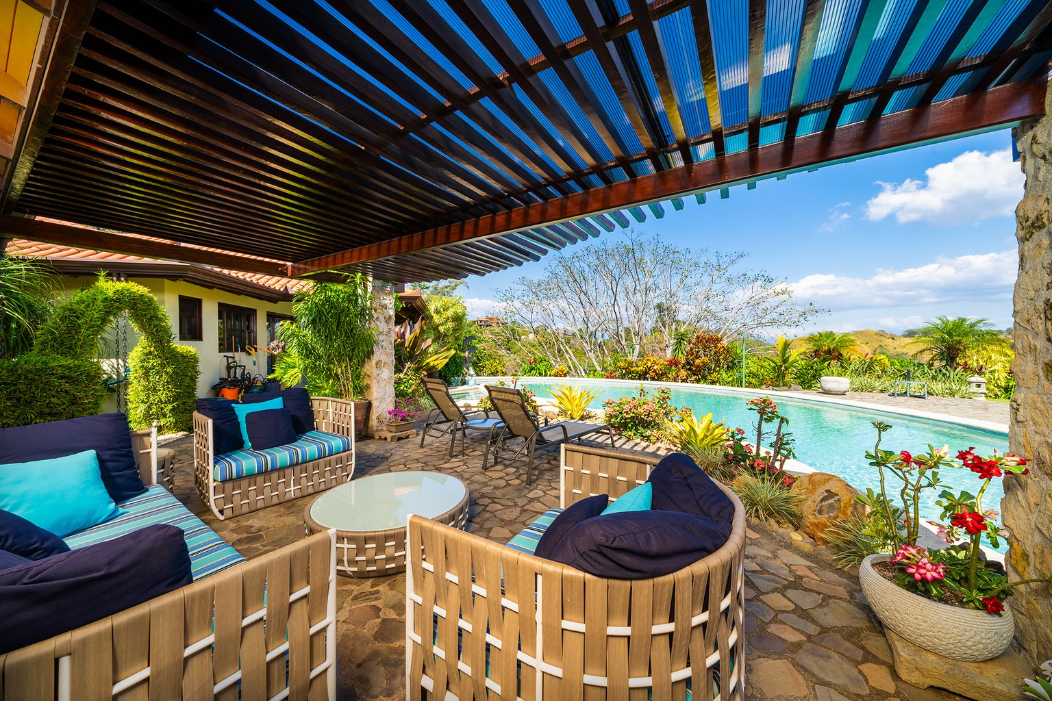 Luxury patio with pool and tropical landscaping