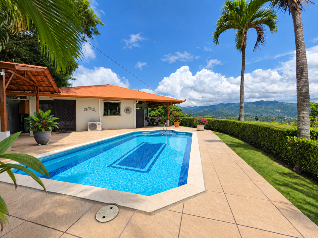 Tropical hillside home with pool and mountain views